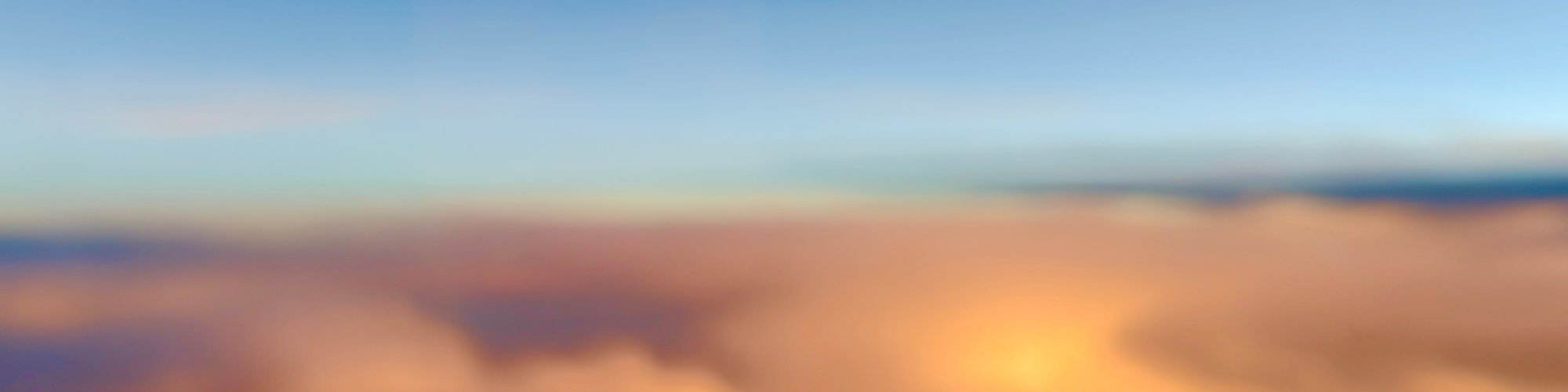 Sunset above the clouds from a plane window